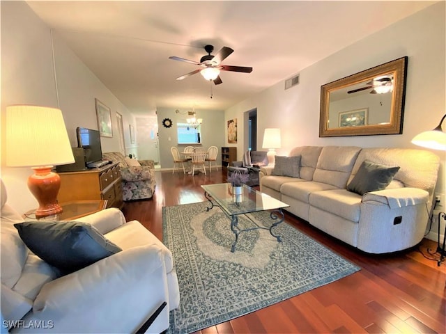 living room with visible vents, wood finished floors, and ceiling fan with notable chandelier