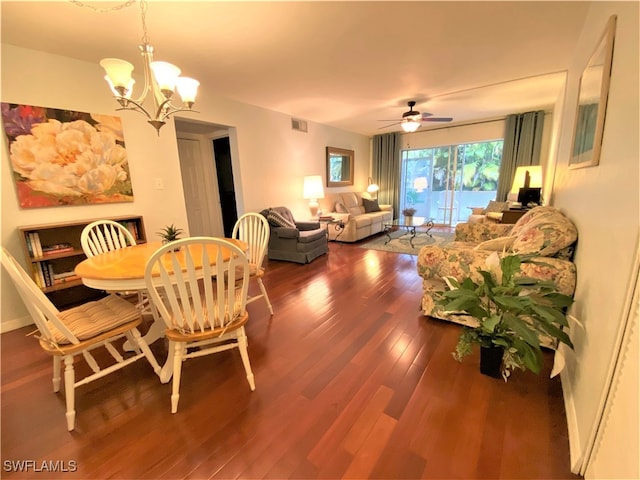 dining space featuring ceiling fan with notable chandelier and wood-type flooring