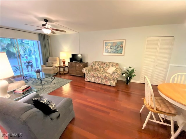 living room with ceiling fan and hardwood / wood-style floors