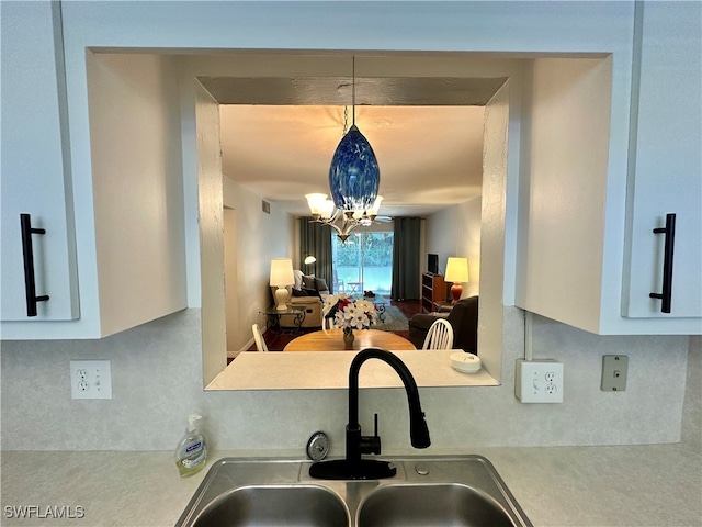 kitchen featuring sink, a notable chandelier, and hanging light fixtures