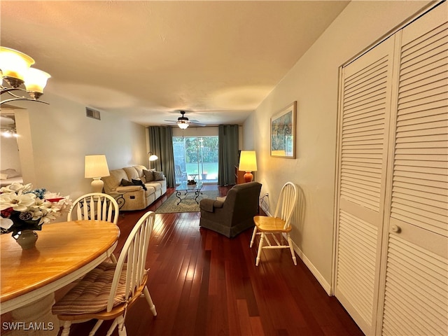 dining space featuring a ceiling fan, dark wood-style flooring, visible vents, and baseboards