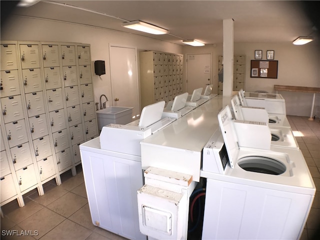 shared laundry area featuring a sink and tile patterned floors