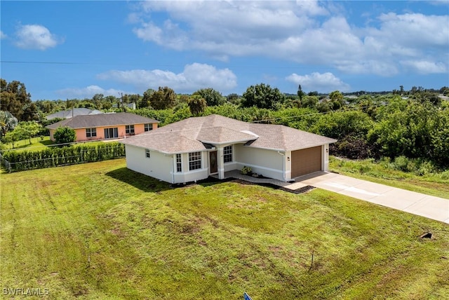 view of front of house featuring a front yard and a garage