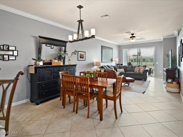 dining area with light tile patterned floors, crown molding, and ceiling fan with notable chandelier