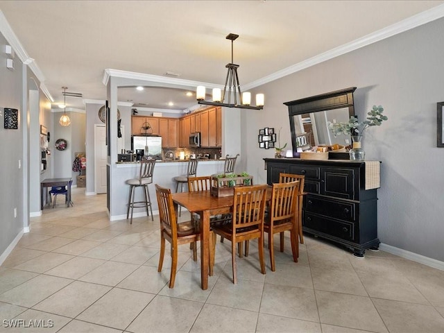 dining area with a notable chandelier, light tile patterned flooring, baseboards, and ornamental molding