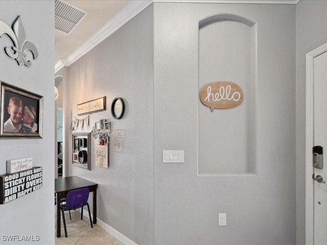 corridor featuring tile patterned floors, baseboards, visible vents, and ornamental molding