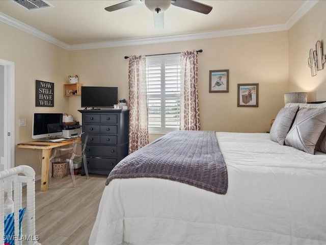 bedroom featuring visible vents, ornamental molding, a ceiling fan, and light wood finished floors