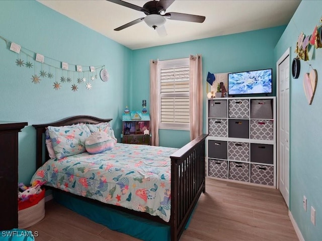 bedroom with wood finished floors and ceiling fan