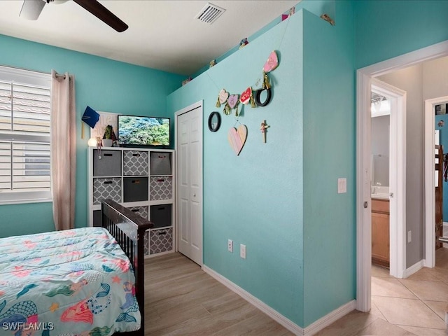 bedroom featuring wood finished floors, visible vents, baseboards, and ceiling fan