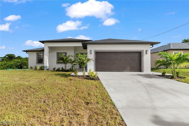 view of front of property featuring a garage and a front lawn