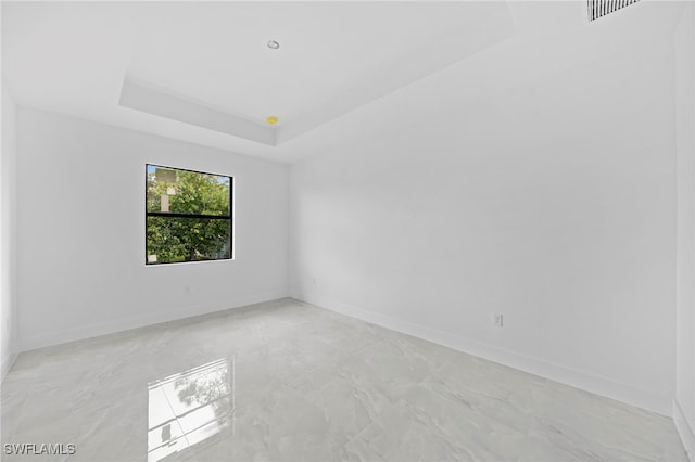 empty room with a tray ceiling