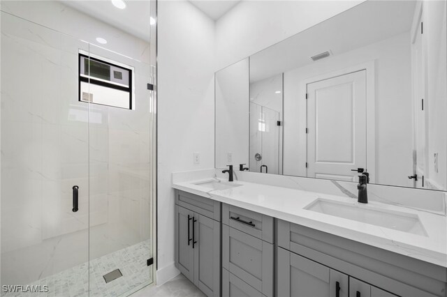 bathroom with vanity and a shower with shower door