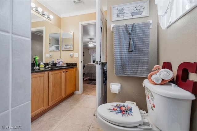 bathroom featuring tile patterned flooring, toilet, vanity, ceiling fan, and ornamental molding