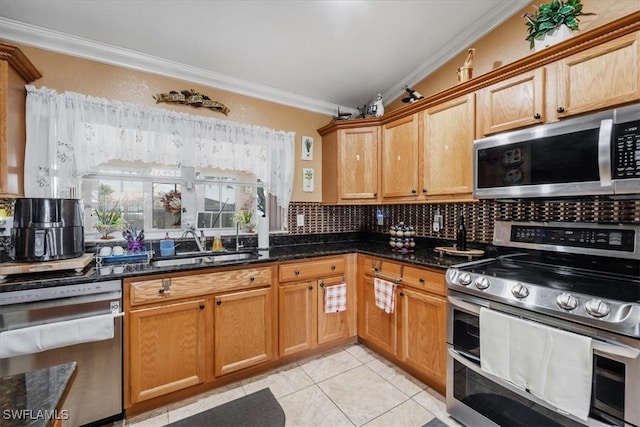 kitchen featuring light tile patterned floors, tasteful backsplash, crown molding, stainless steel appliances, and dark stone counters