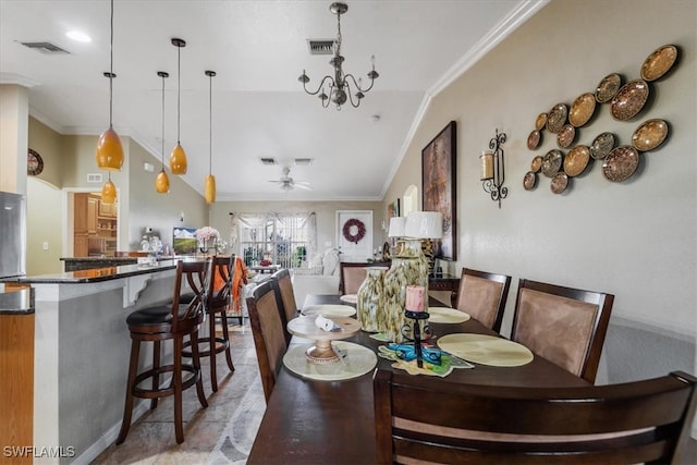 dining area with vaulted ceiling, ornamental molding, and ceiling fan with notable chandelier