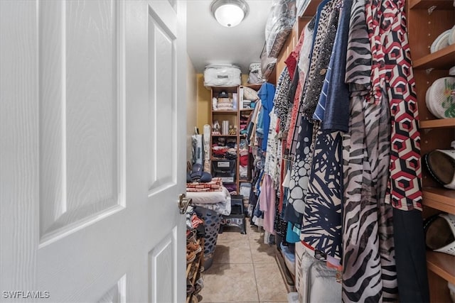 spacious closet with light tile patterned floors