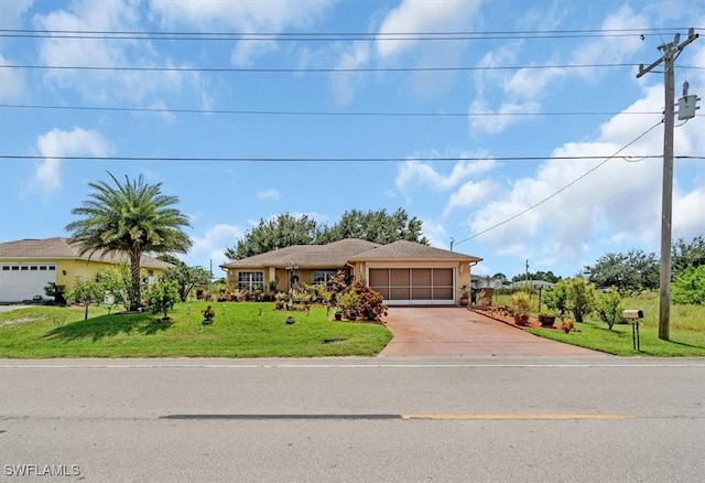 view of front of house with a garage and a front lawn