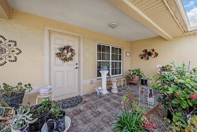 property entrance featuring a patio area