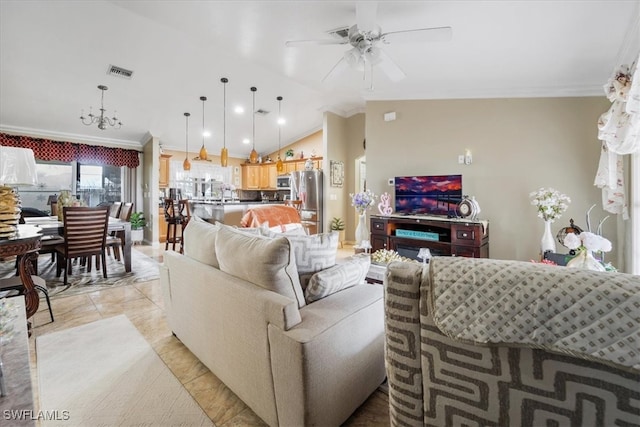 living room with lofted ceiling, ceiling fan with notable chandelier, and ornamental molding