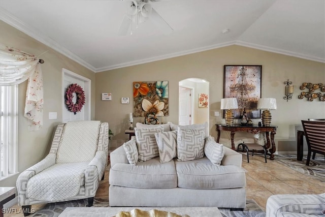 living room with lofted ceiling, ceiling fan, ornamental molding, and light tile patterned floors