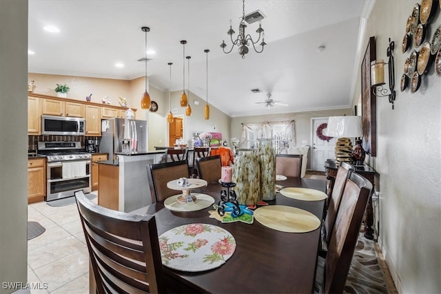 dining space featuring ceiling fan with notable chandelier, ornamental molding, light tile patterned floors, and lofted ceiling