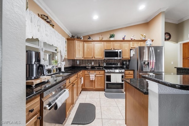 kitchen featuring dark stone counters, crown molding, vaulted ceiling, sink, and appliances with stainless steel finishes