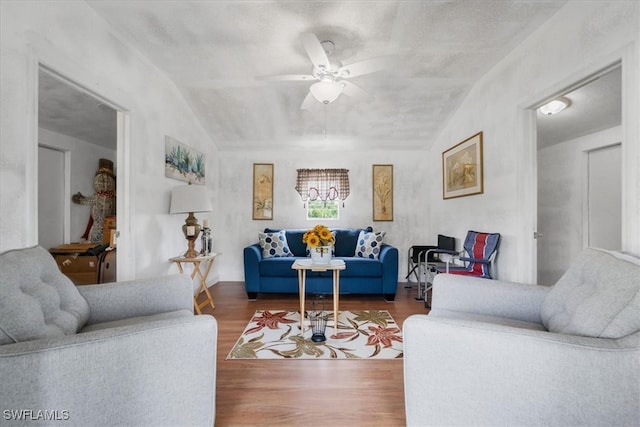 living room featuring lofted ceiling, ceiling fan, and hardwood / wood-style flooring