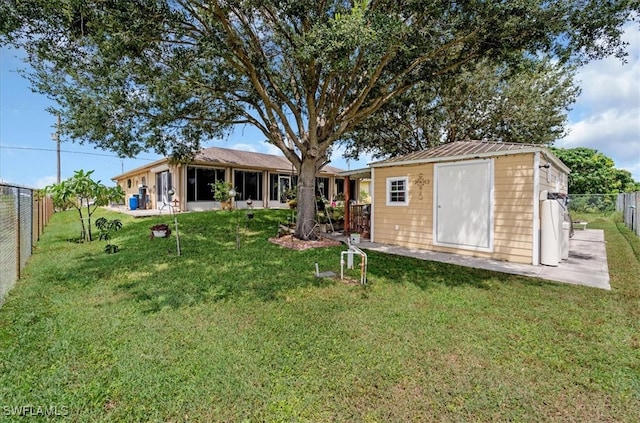 back of property with a yard and a storage unit