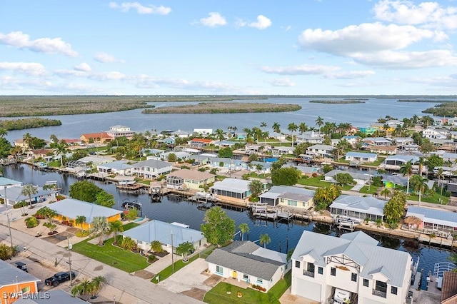 drone / aerial view with a water view and a residential view