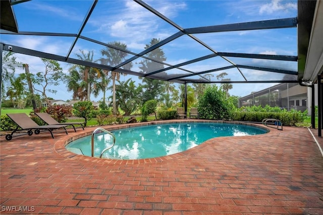 view of swimming pool featuring a patio area and a lanai