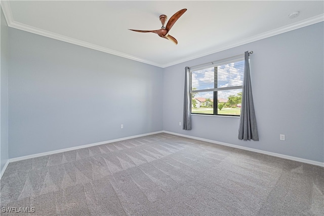 carpeted spare room featuring ceiling fan and ornamental molding