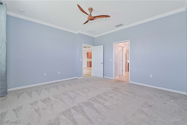 interior space featuring crown molding, ceiling fan, and light carpet