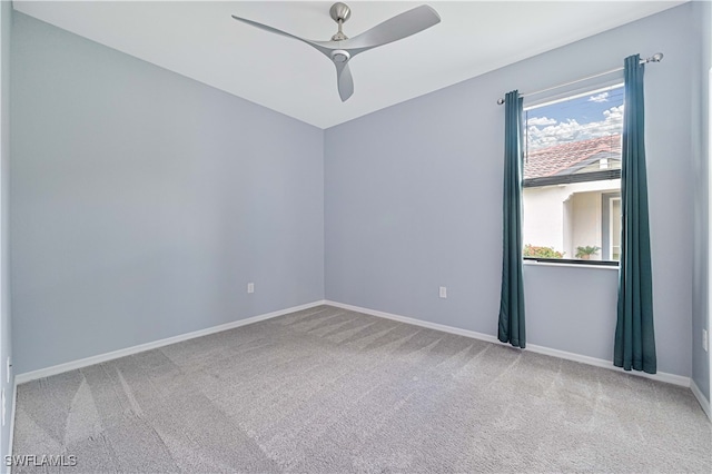 carpeted empty room featuring ceiling fan