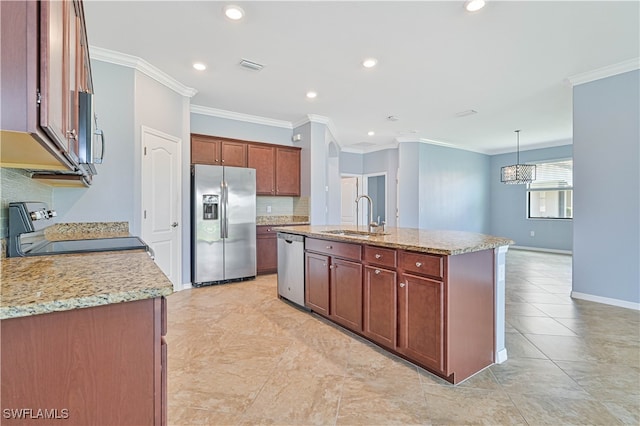 kitchen featuring hanging light fixtures, appliances with stainless steel finishes, light stone countertops, sink, and a kitchen island with sink