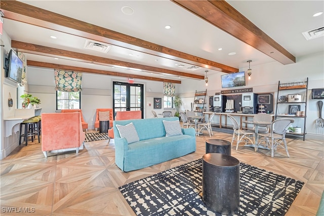 living room with beam ceiling and light parquet flooring