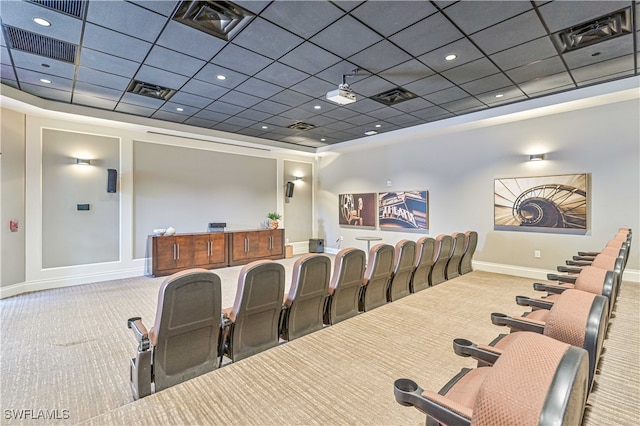 carpeted home theater room featuring a paneled ceiling