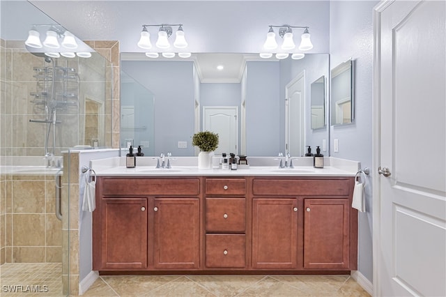 bathroom with ornamental molding, vanity, tile patterned floors, and a shower with door