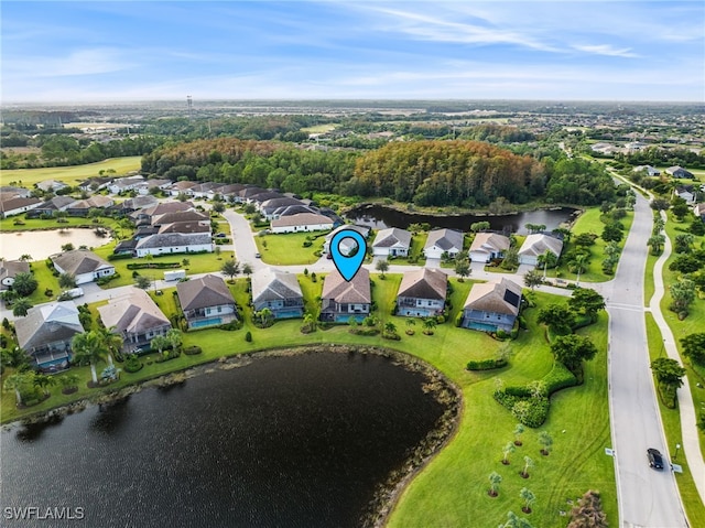 drone / aerial view featuring a residential view and a water view