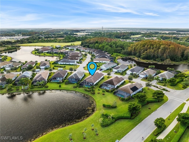 birds eye view of property with a water view