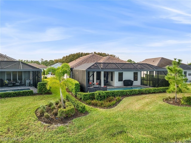 back of house with a lanai, a swimming pool, a patio, and a lawn