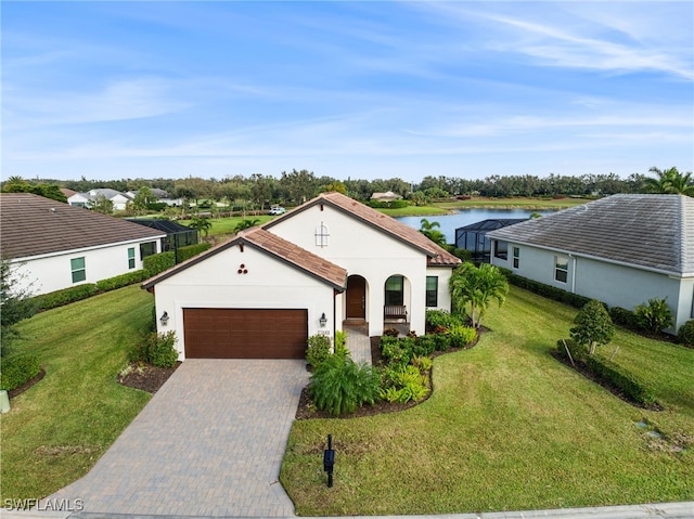 view of front facade with a garage, a water view, and a front lawn