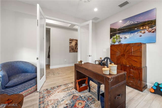 office space featuring french doors and light wood-type flooring