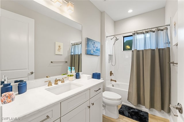 full bathroom featuring shower / bath combo, vanity, and toilet