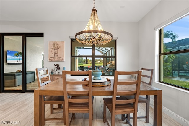 dining space featuring a chandelier and wood-type flooring