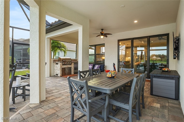 exterior space with ceiling fan, grilling area, area for grilling, outdoor dining area, and glass enclosure