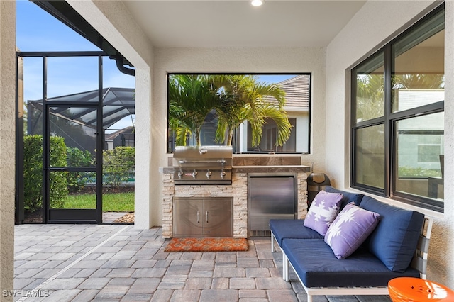 sunroom featuring a healthy amount of sunlight and an outdoor stone fireplace