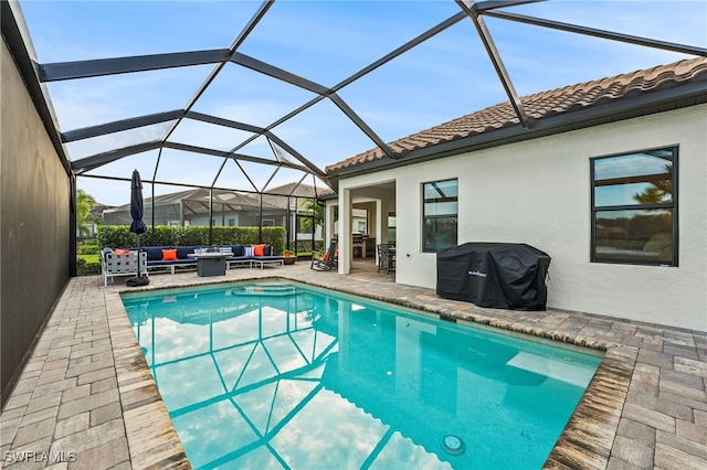 view of swimming pool featuring a lanai, outdoor lounge area, a patio area, and grilling area