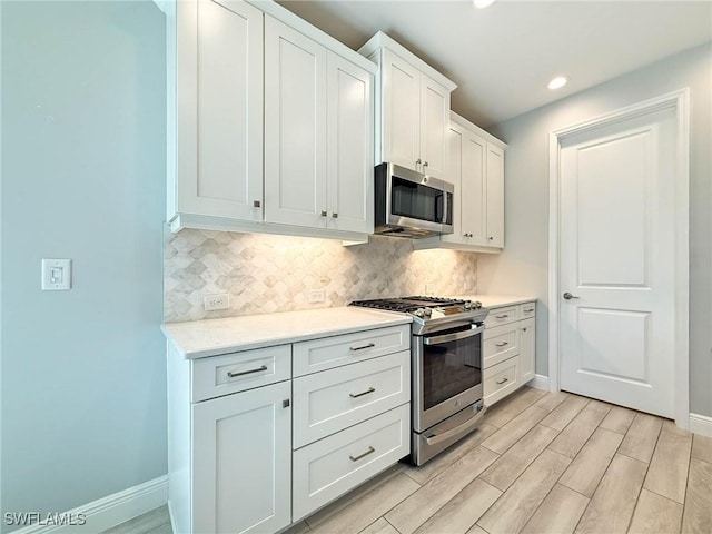 13840 Amblewind Cove Way, Fort Myers, FL 33905 - kitchen featuring stainless steel appliances, baseboards, tasteful backsplash, light countertops, and recessed lighting