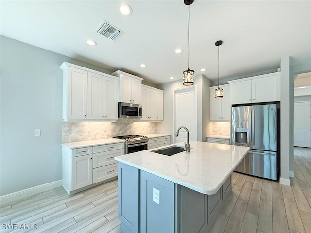 13840 Amblewind Cove Way, Fort Myers, FL 33905 - kitchen featuring appliances with stainless steel finishes, a sink, wood finish floors, backsplash, and recessed lighting