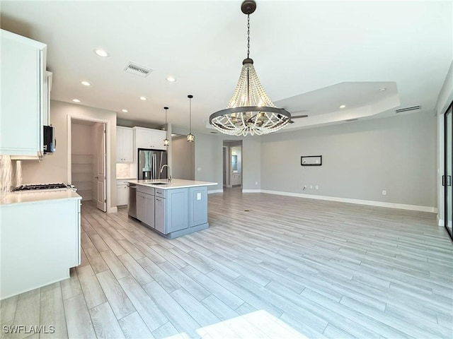 13840 Amblewind Cove Way, Fort Myers, FL 33905 - kitchen featuring a sink, stainless steel appliances, open floor plan, a chandelier, and light countertops
